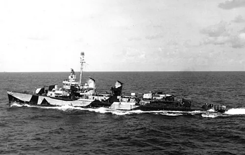 The U.S. Navy destroyer USS Evans (DD-552) on 5 October 1944, pulling away from the escort carrier USS Sargent Bay (CVE-83), not visible.