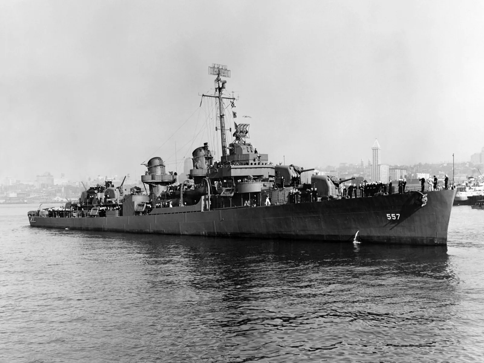 The U.S. Navy destroyer USS Johnston (DD-557) off Seattle, Washington (USA), on 27 October 1943. Smith Tower is in the background over the bow of the ship.