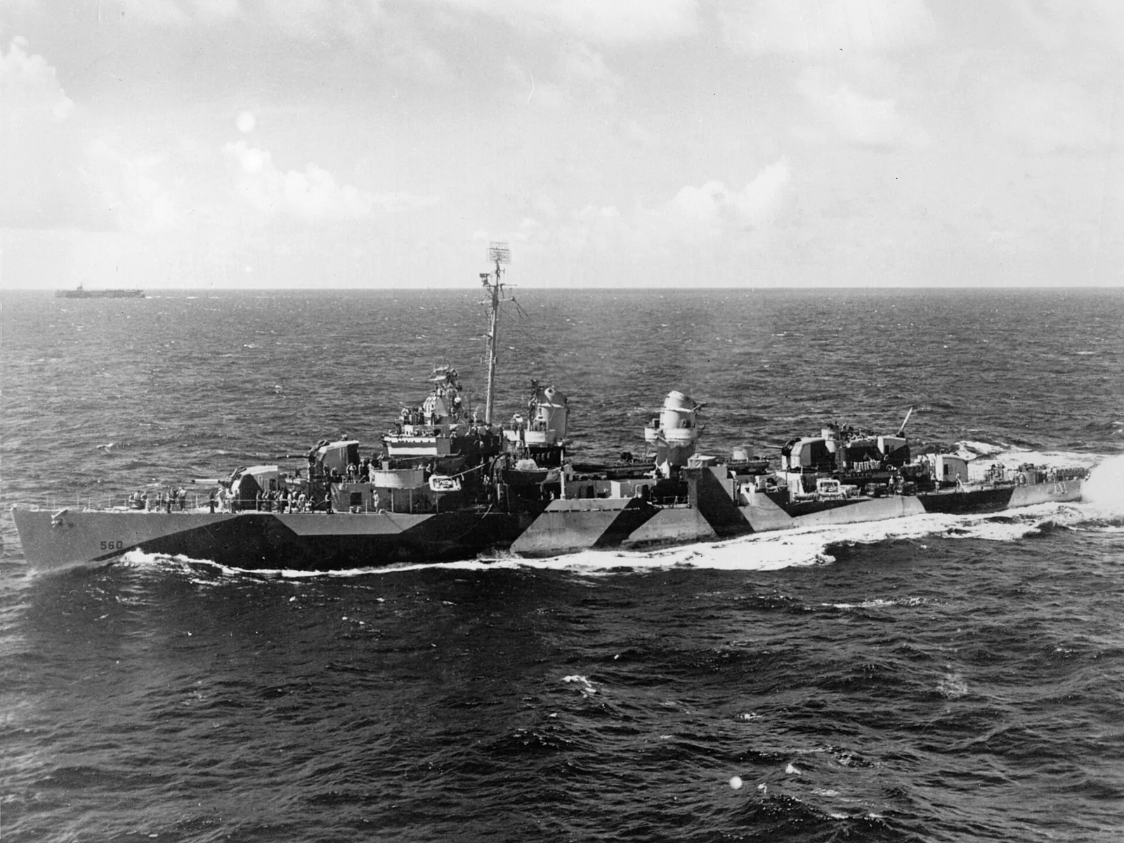 The U.S. Navy destroyer USS Morrison (DD-560) underway, viewed from the escort carrier USS Gambier Bay (CVE-73), 24 July 1944. The ship is painted in Camouflage Measure 32, Design 13D.
