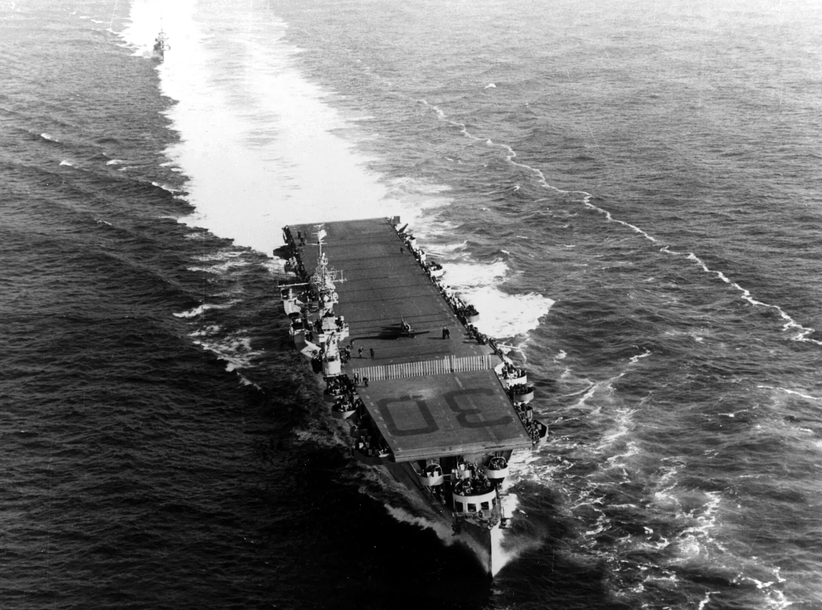 USS San Jacinto (CVL-30) underway off the U.S. East Coast (position 36 55'N, 75 07'W) on 23 January 1944, with a North American SNJ Texan training plane parked on her flight deck.