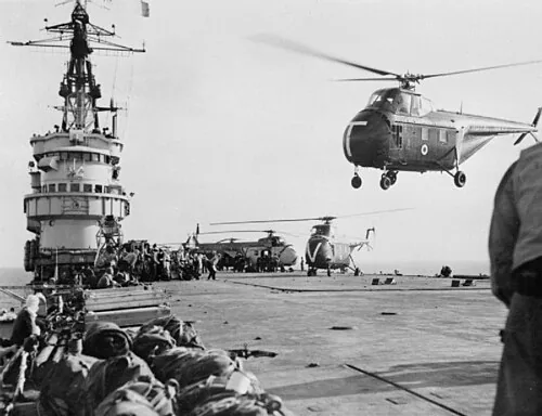 Royal Navy Westland Whirlwind helicopters taking the first men of 45 Royal Marine Commando into action at Port Said from the commando carrier HMS Theseus (R64) during "Operation Musketeer".