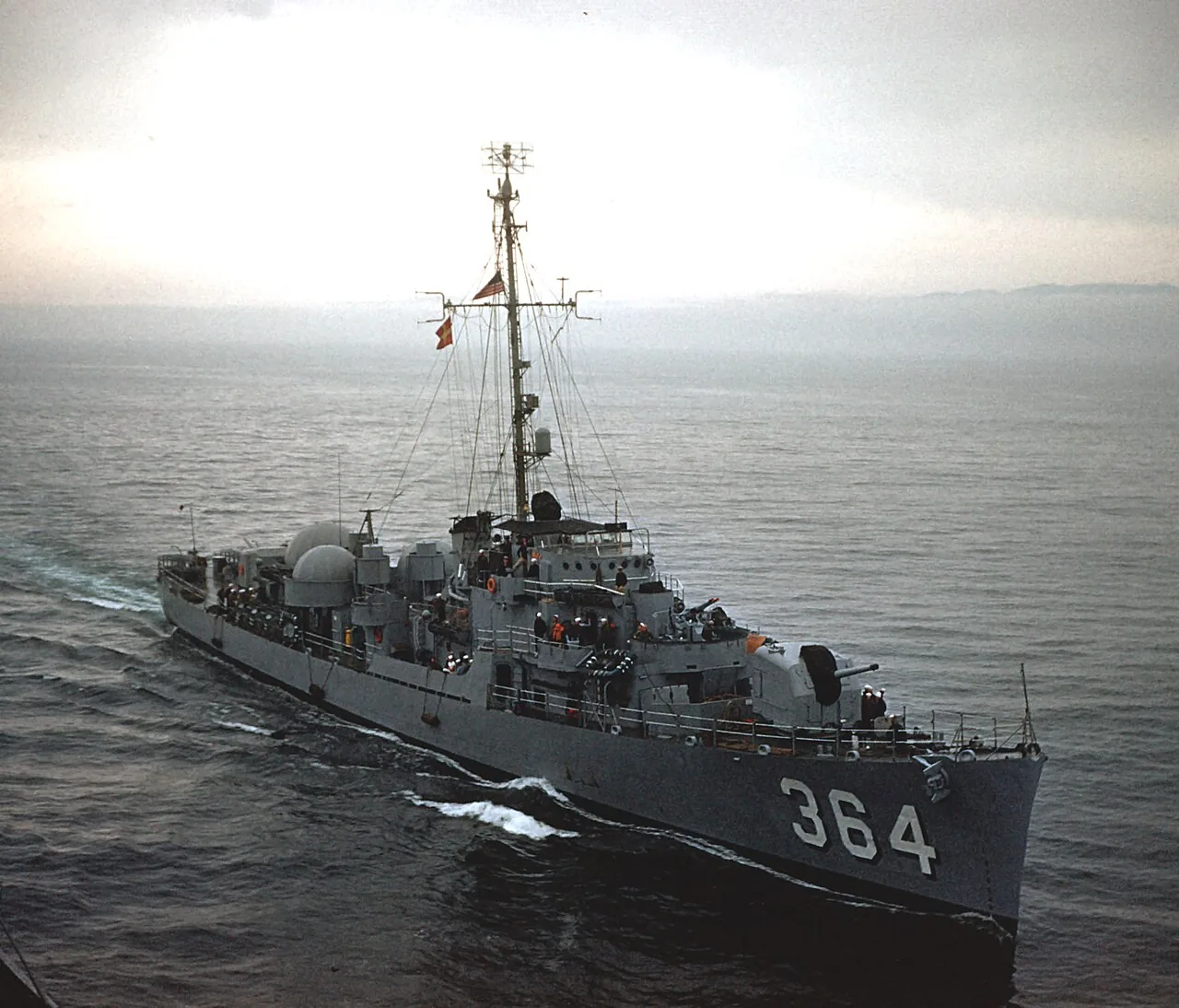 The U.S. Navy destroyer escort USS Rombach (DE-364) underway in the Pacific Ocean during exercises, in 1954.