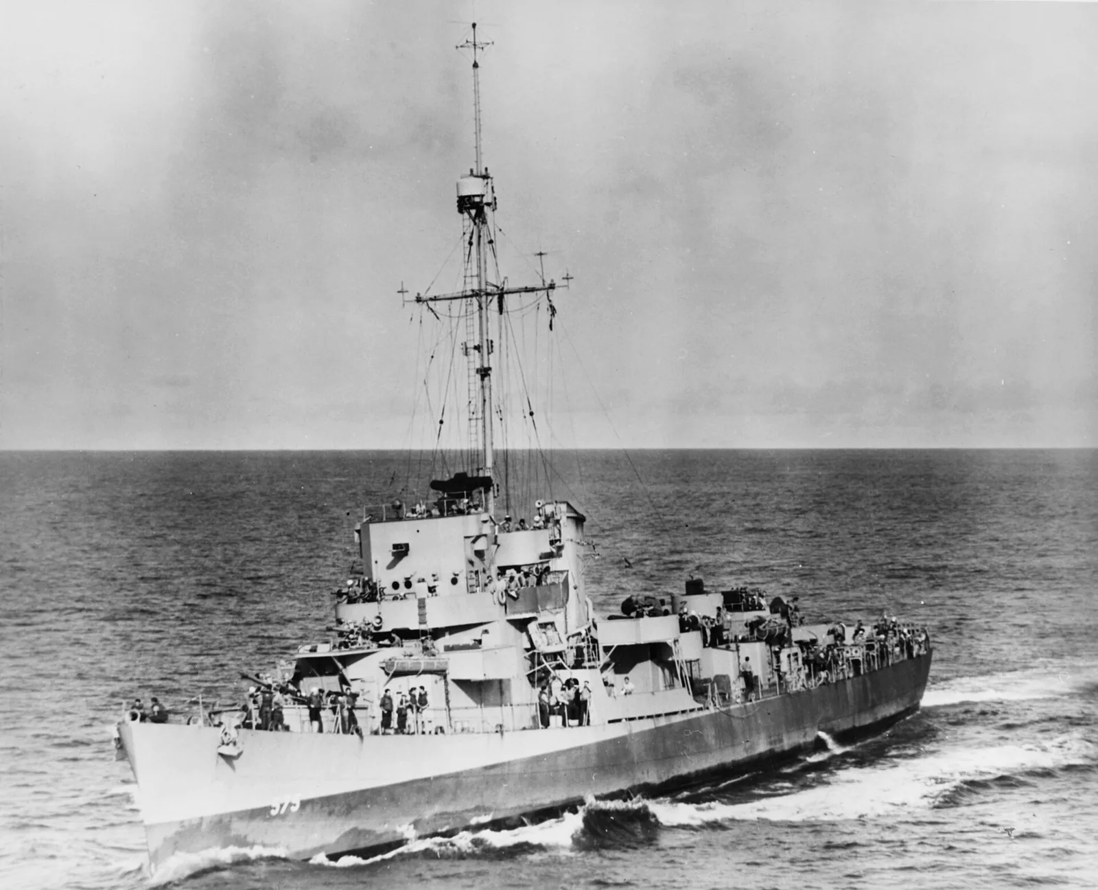 USS Ahrens (DE-575) underway in the Atlantic Ocean on 13 May 1944, seen from the escort carrier USS Bogue (CVE-9). Note the High Frequency Direction Finder (HF/DF) antenna mounted on Ahrens 's foremast peak.