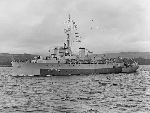 Photograph of British Algerine class minesweeper HMS Niger (J73) underway, coastal waters.