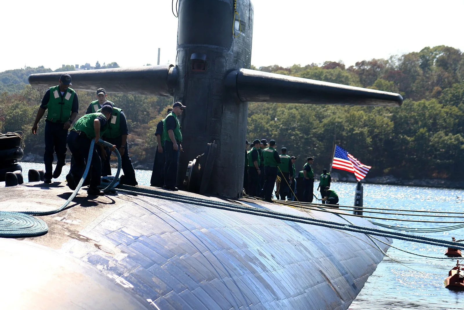 USS Augusta (SSN 710) work together to moor their submarine to the pier. Augusta arrived home to Submarine Base New London, Conn., after a routine six-month deployment to the Mediterranea...