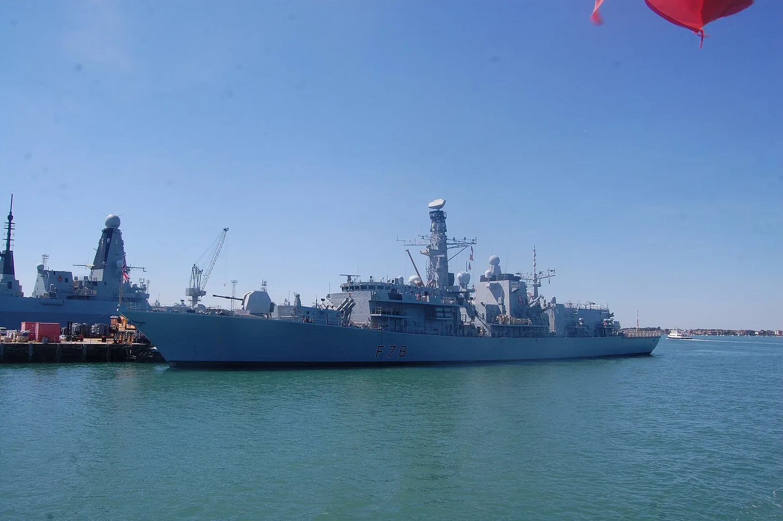 HMS Kent (F78) at HMNB Portsmouth, City of Portsmouth, England, viewed from a boat in Portsmouth Harbour.
