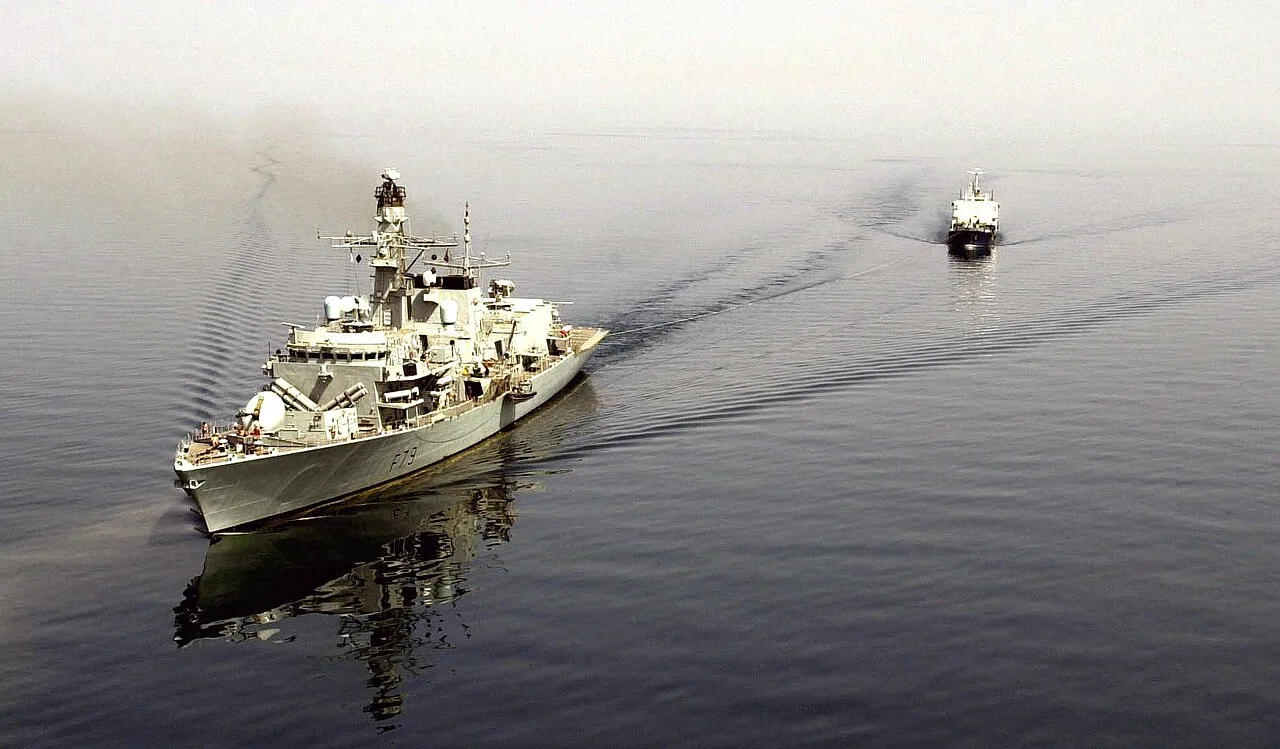 HMS Portland (F79), underway with an Iraqi Commercial Oil Tanker in tow. The Iraqi vessel was boarded and seized after it was found to be carrying an illegal cargo of fuel oil....