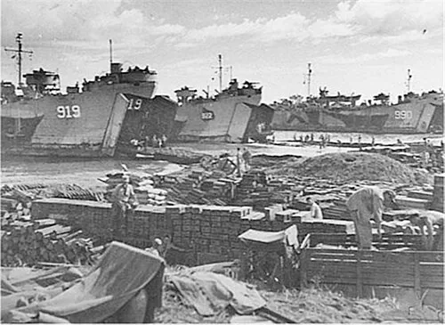 USS LST-919 USS LST-922 and USS LST-990 beached at Mindoro Island, P.I., 15 December 1944, unloading supplies and equipment.