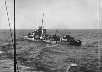 HMAS NESTOR (G02) LISTING TO PORT AND ABANDONED AFTER SUFFERING FATAL DAMAGE TO HER BOILER ROOMS IN A BOMBING ATTACK. NOTE THE HAMMOCKS DRAPED OVER THE SIDE FOR USE AS FENDERS WHEN THE DESTROYER HMS JAV...