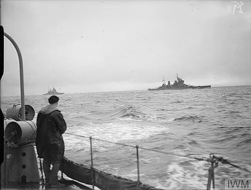 HM SHIPS CARRYING OUT BATTLE PRACTICE AT SEA. SEPTEMBER 1941, ON BOARD THE DESTROYER HMS BEDOUIN. HMS KING GEORGE V with HMS PRINCE OF WALES astern steaming at sea during firing practice.